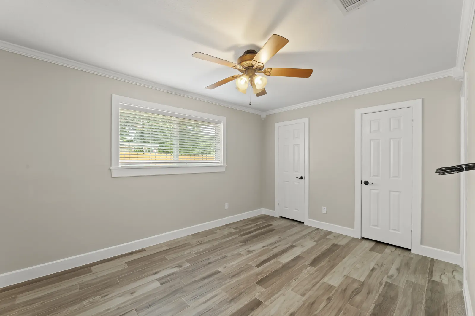 Bedroom with ceiling fan and two closets