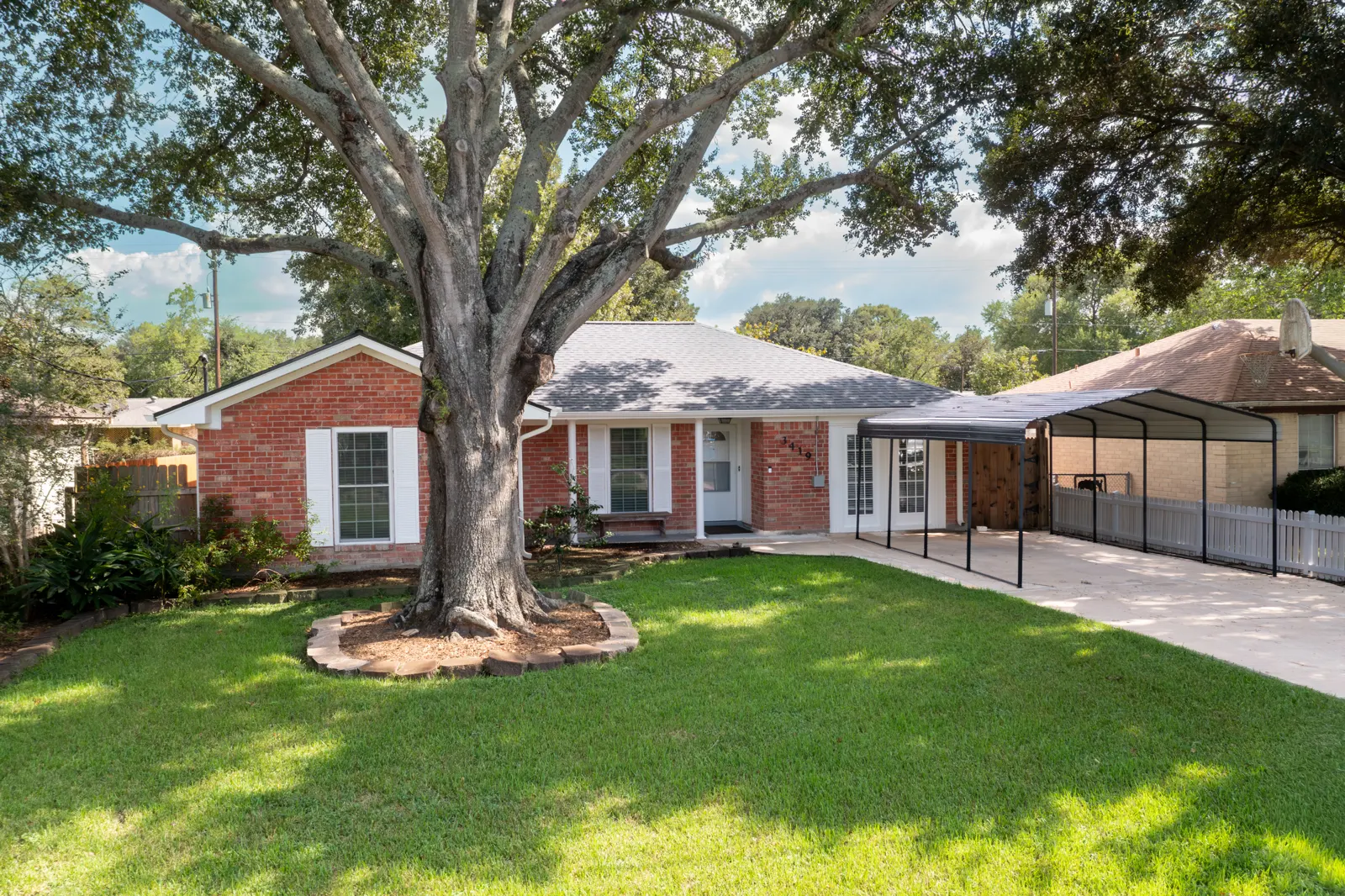 Front of the home under a large oak tree